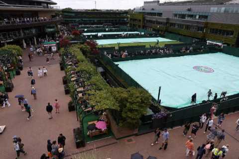 Wimbledon ALREADY suspended within first hour as rain pours and fans wait in soggy queue for last-minute tickets