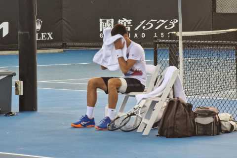Fears Djokovic could pull out of Australian Open as he practises with heavily-strapped leg after cancelling session