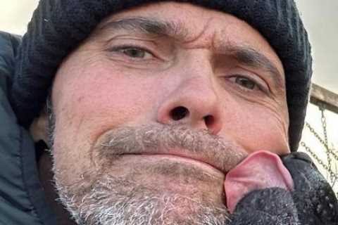 Former Wimbledon finalist looks unrecognisable with stubbly grey beard as he walks dog with family