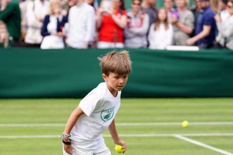 Reigning champ Novak Djokovic practices with his young son on his first day of Wimbledon